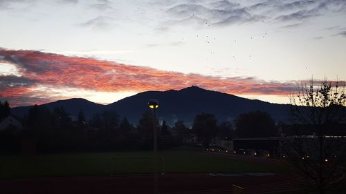 Scenic view of silhouette mountains against sky at sunset