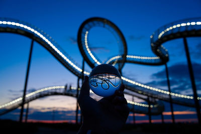 Portrait of man on bridge against blue sky