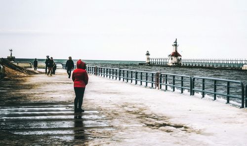 People on beach against clear sky