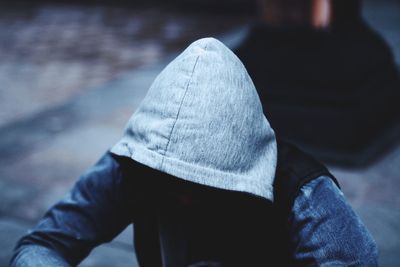 High angle view of man wearing hooded shirt on street