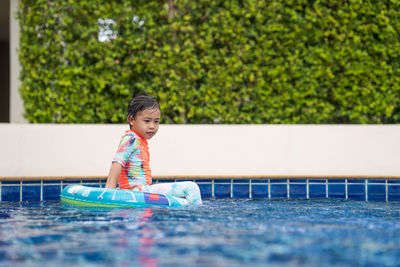 Little adorable girl have fun at outdoor swimming pool