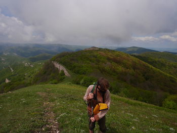 Front view of man on top of mountain