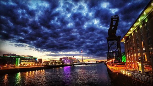architecture, built structure, building exterior, sky, cloud - sky, water, waterfront, cloudy, river, illuminated, weather, city, reflection, bridge - man made structure, connection, storm cloud, cloud, overcast, dusk, outdoors