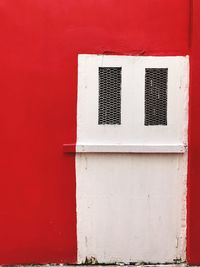 Close-up of window on red wall