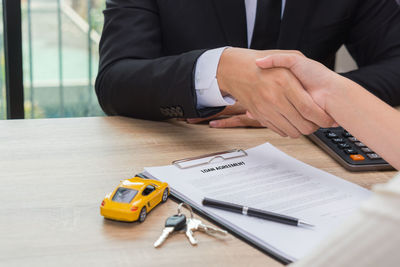 Midsection of man working on table