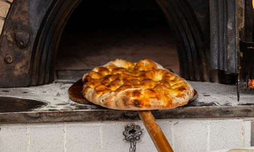 Production of baked bread with a wood oven in a bakery.