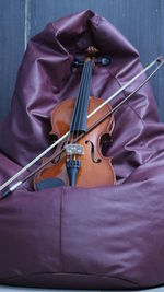 Violin over bean bag against wall