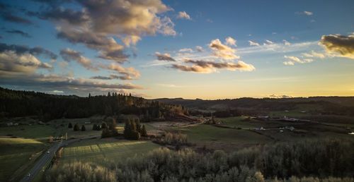 Scenic view of field against sky during sunset