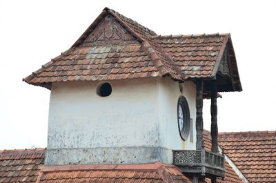 Close-up of birdhouse on roof against sky