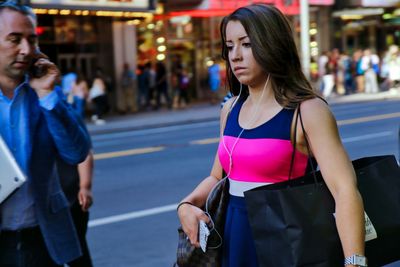 Beautiful woman standing on street in city