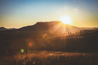 Scenic view of field against sky during sunset