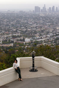 High angle view of man walking on street amidst buildings in city