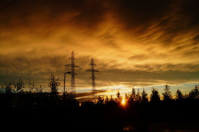 Silhouette trees against sky during sunset