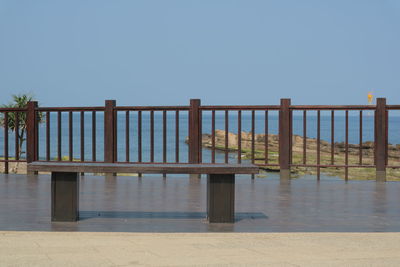 Wooden pier on sea against clear sky