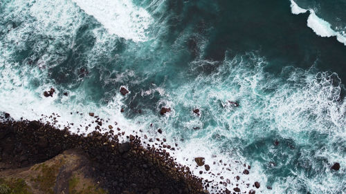 High angle view of rocks in ocean