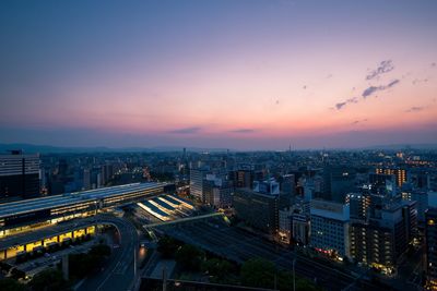 High angle view of illuminated buildings against sky during sunset