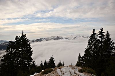 Scenic view of mountains against cloudy sky