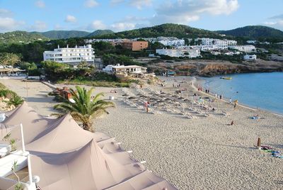 High angle view of beach by buildings against sky