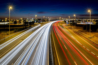 High angle view of light trails on highway at night