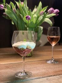 Glass of red and white wine in vase on table