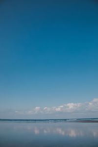 Scenic view of sea against blue sky