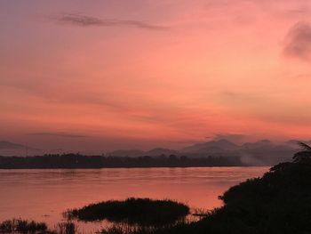 Scenic view of lake against romantic sky at sunset