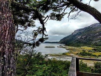 Scenic view of sea and mountains against sky