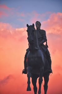 Low angle view of statue against cloudy sky