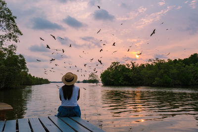 Rear view of woman standing in lake