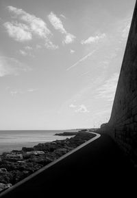 Road by sea against sky