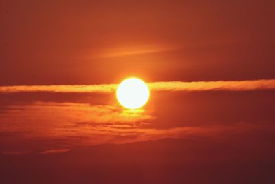 Low angle view of sun in sky during sunset