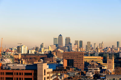 Modern buildings in city against clear sky