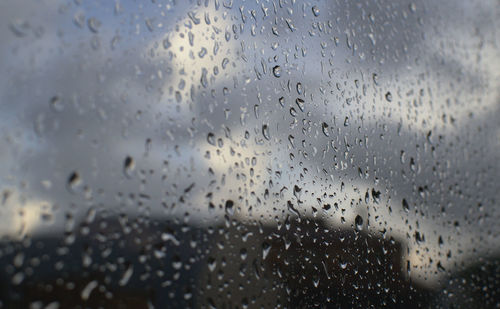 Waterdrops on glass against blurred background