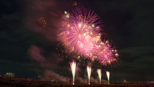 Low angle view of firework display at night