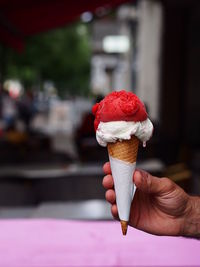 Hand holding ice cream cone