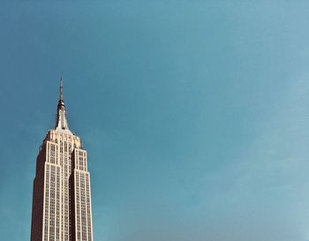 Low angle view of modern building against blue sky