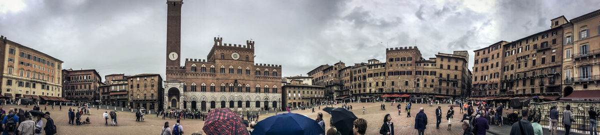 Panoramic view of crowd on street against buildings