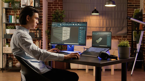 Businesswoman using laptop at office