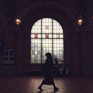 Full length of woman standing in illuminated building