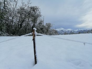 Snow covered field against sky