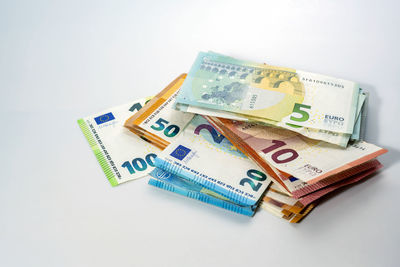 Close-up of paper currencies on white background