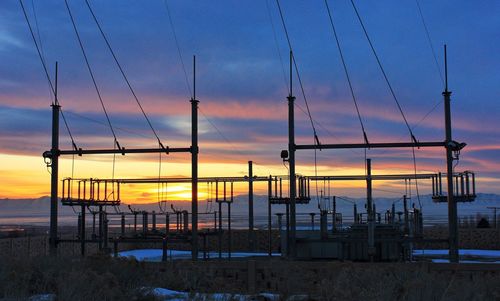 Low angle view of cables against clouds