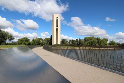 Retaining wall by lake burley griffin against sky