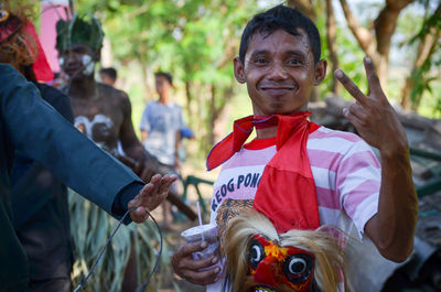 Portrait of smiling man showing peace sign