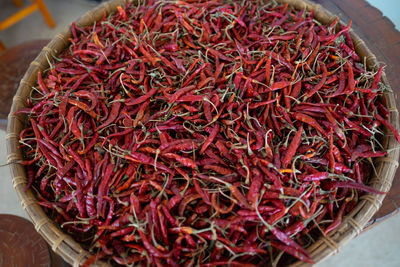 High angle view of red chili peppers in basket for sale