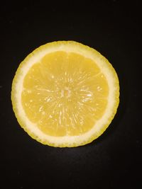 Close-up of lemon slice on black background