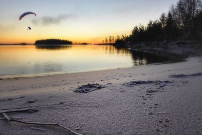 Scenic view of beach against sky during sunset