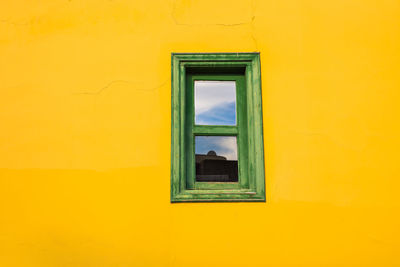 Close-up of yellow window of building