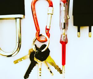 Close-up of hanging on table against white background