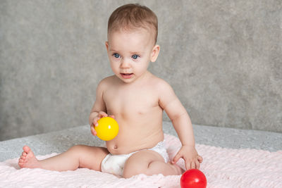 Portrait of cute baby boy with toy